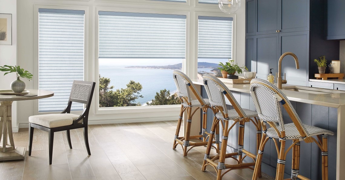 Navy and white kitchen/dining room with vertical blinds over window with water view