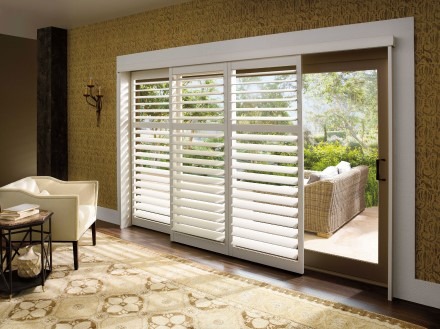 Living room overlooking patio with shutter-covered sliding door