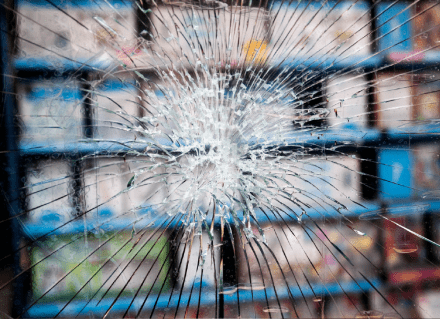 Broken glass in front of electronics store