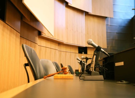 Wood-grain film on curved wall behind judge podium