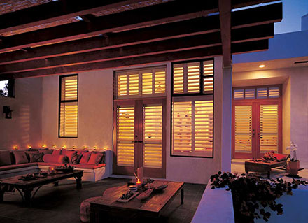 The outside of a home with Hunter Douglas NewStyle plantation shutters, perfect for Cocoa Beach families.