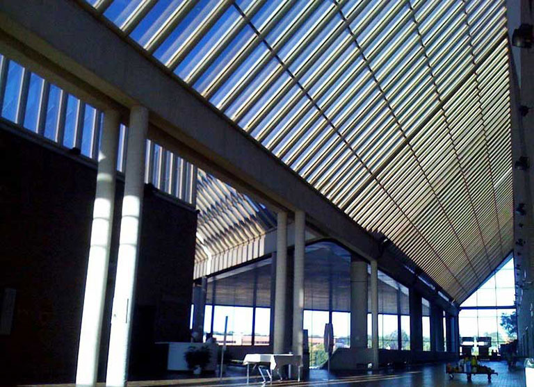 Government building with slatted glass hip roof.