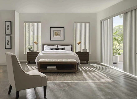 Vertical blinds cover the windows in this coastal decorated bedroom to illustrate Merritt Islands blinds.
