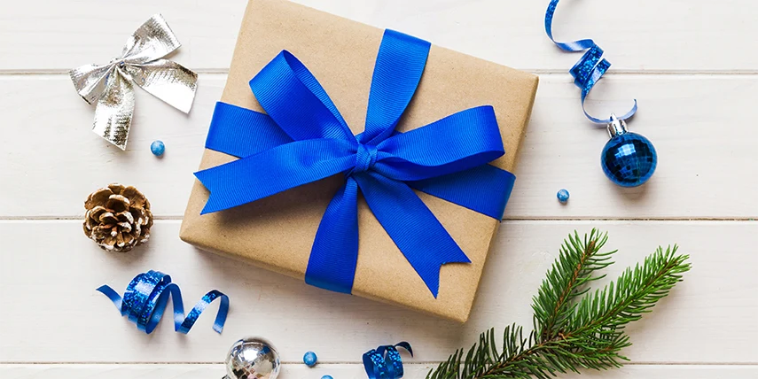 A gift certificate box wrapped in brown and blue ribbon.